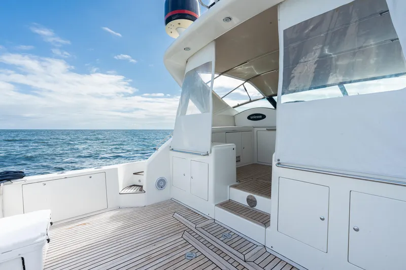 Slide: The Image of 2001 Uniesse 48 Open yacht deck with ocean view and clear skies. - 27