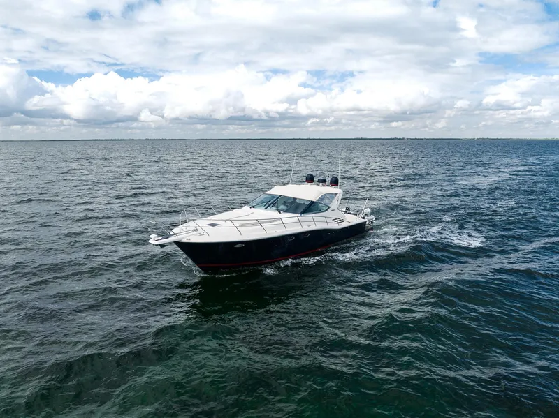 Slide: The Image of Uniesse 48 Open 2001 yacht cruising on open sea under cloudy sky. - 28