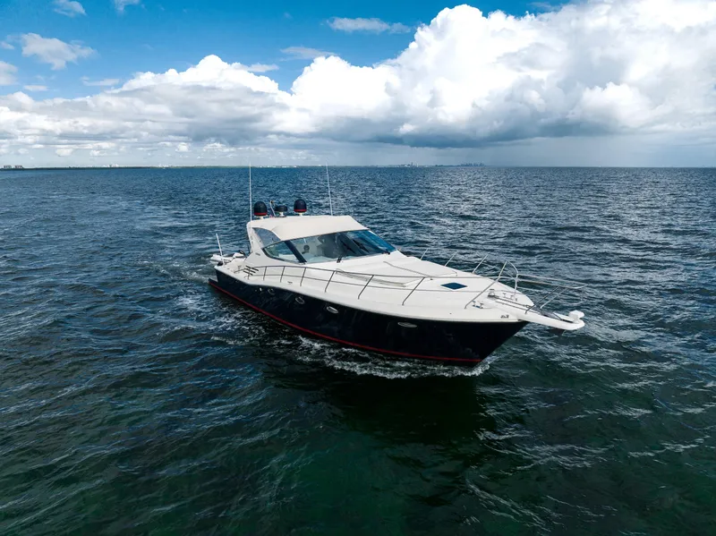 Slide: The Image of Uniesse 48 Open 2001 yacht cruising on open sea under cloudy sky. - 3