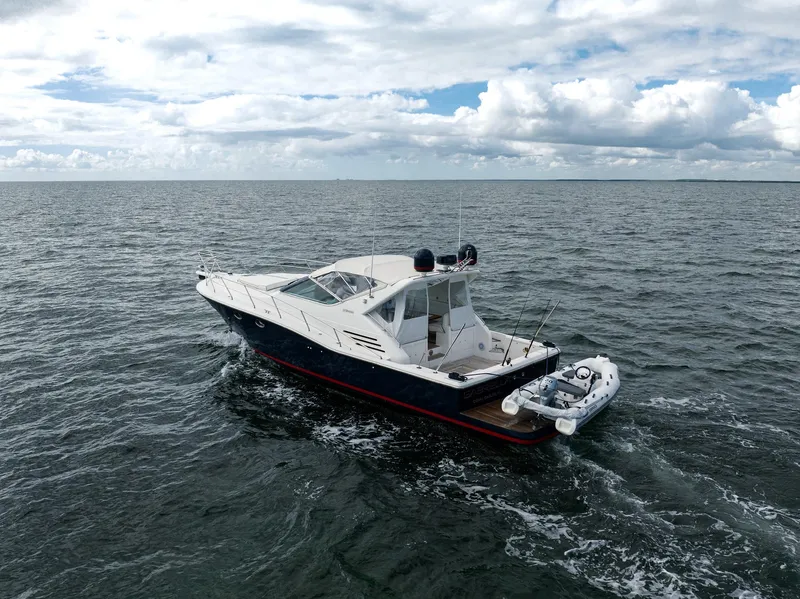 Slide: The Image of 2001 Uniesse 48 Open yacht cruising on open water under cloudy skies. - 31