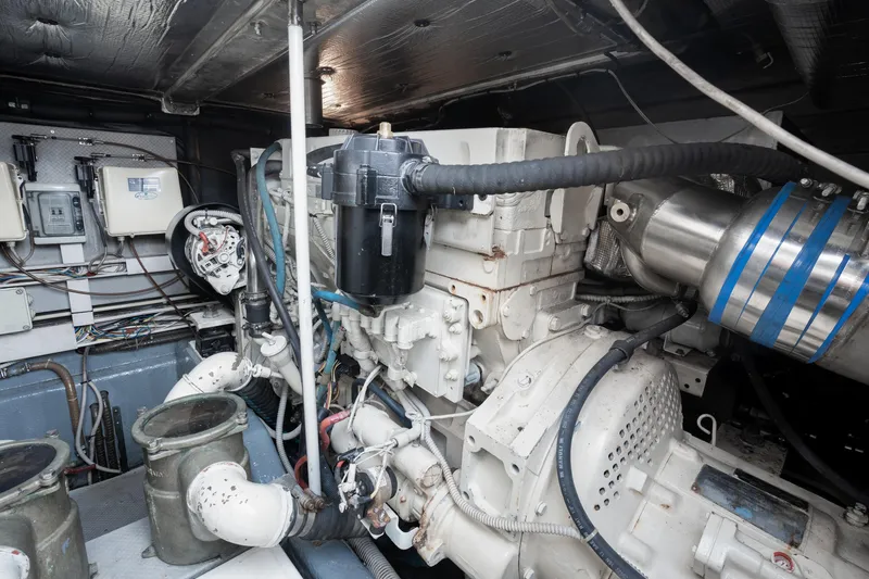 Slide: The Image of Engine room of 2001 Uniesse 48 Open yacht, showcasing mechanical components and wiring. - 34