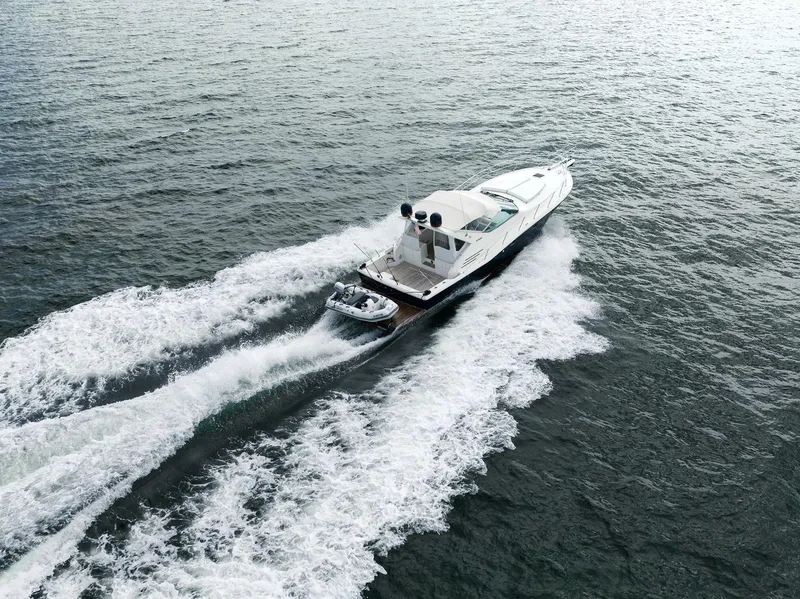 Slide: The Image of Uniesse 48 Open 2001 yacht cruising on open water, aerial view. - 4