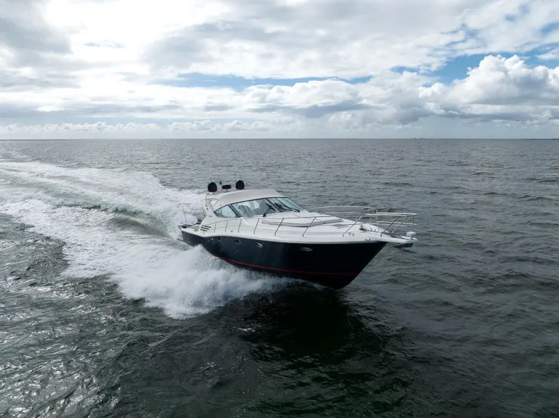 Slide: The Image of 2001 Uniesse 48 Open yacht cruising on open sea under cloudy sky. - 5