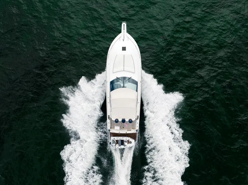 Slide: The Image of Aerial view of 2001 Uniesse 48 Open yacht cruising on the water. - 6