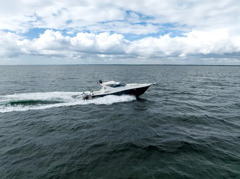 Slide: The Image of Uniesse 48 Open 2001 yacht cruising on open sea under cloudy sky. - 7