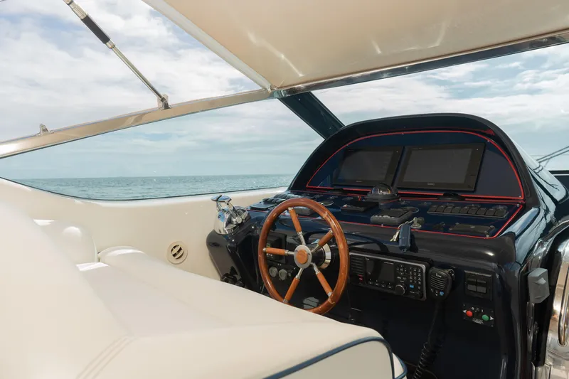 Slide: The Image of Uniesse 48 Open 2001 yacht helm with wooden steering wheel and navigation equipment. - 8
