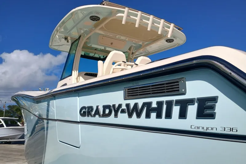 Slide: The Image of Grady-White Canyon 336 boat, 2026 model, under blue sky. - 3