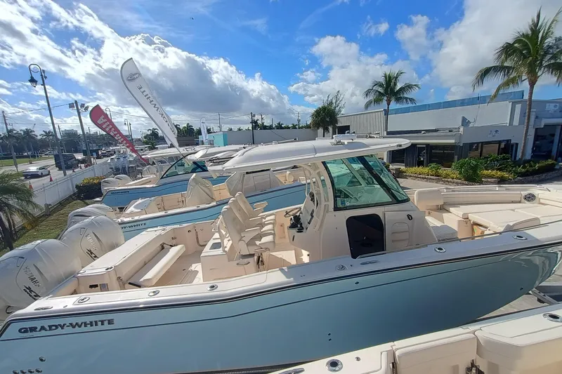 Slide: The Image of Grady-White Canyon 336 boat, 2026 model, displayed in a sunny showroom. - 6