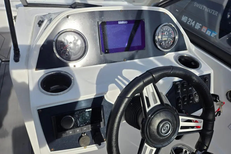 Slide: The Image of 2024 Godfrey Hurricane 235SD boat dashboard with steering wheel and gauges. - 10
