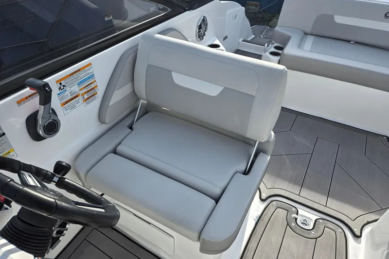 Slide: The Image of 2024 Godfrey Hurricane 235SD boat interior with steering wheel and seating area. - 14