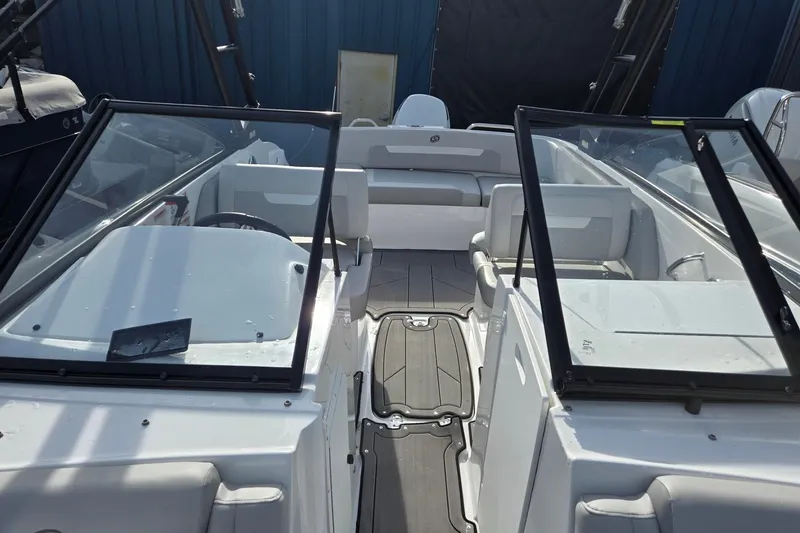 Slide: The Image of 2024 Godfrey Hurricane 235SD boat interior with seating and windshield. - 15