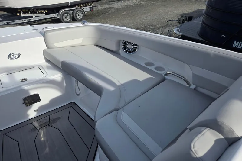 Slide: The Image of 2024 Godfrey Hurricane 235SD boat interior with cushioned seating and cup holders. - 19
