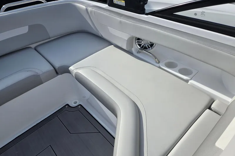 Slide: The Image of 2024 Godfrey Hurricane 235SD boat interior with cushioned seating and cup holders. - 25