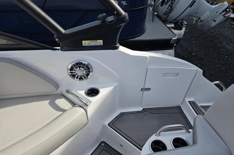 Slide: The Image of 2024 Godfrey Hurricane 235SD boat interior with seating, cup holders, and speaker. - 26