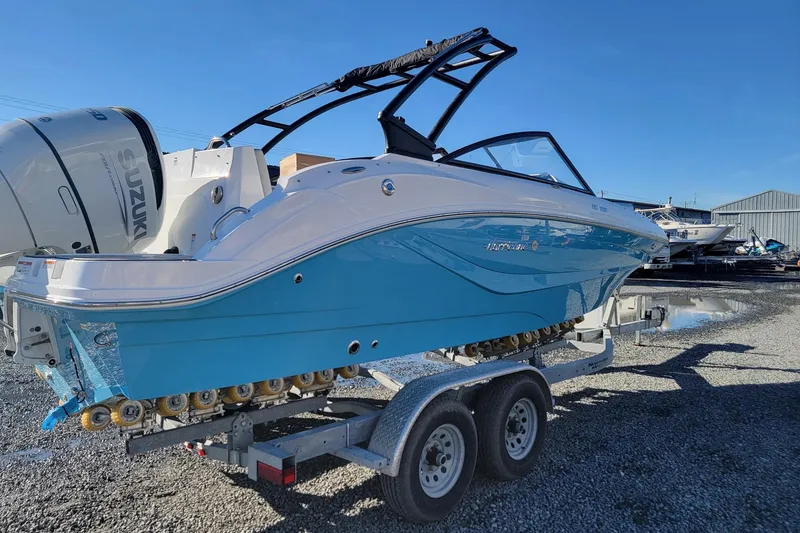 Slide: The Image of 2024 Godfrey Hurricane 235SD boat on trailer, blue and white design, Suzuki engine. - 3