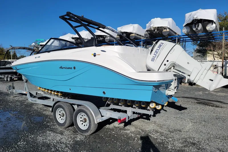 Slide: The Image of 2024 Godfrey Hurricane 235SD boat on trailer with Suzuki outboard motor. - 4