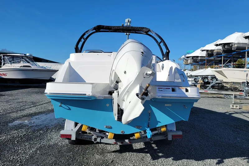 Slide: The Image of 2024 Godfrey Hurricane 235SD boat on trailer, rear view, blue and white design. - 5