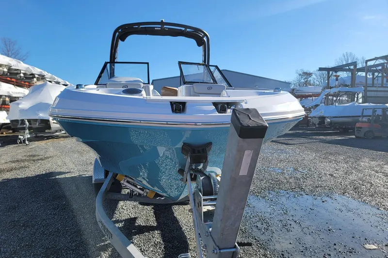 Slide: The Image of 2024 Godfrey Hurricane 235SD boat on trailer, parked outdoors on gravel. - 6