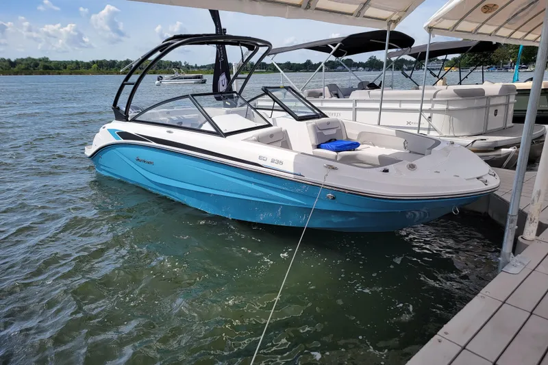 Slide: The Image of 2024 Godfrey Hurricane 235SD boat docked on a sunny day. - 7