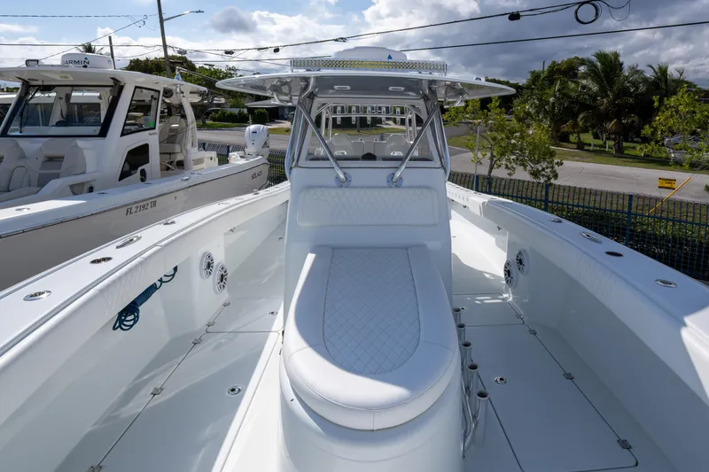 Slide: The Image of 2022 Freeman 34 boat with sleek white design, docked outdoors under cloudy sky. - 10