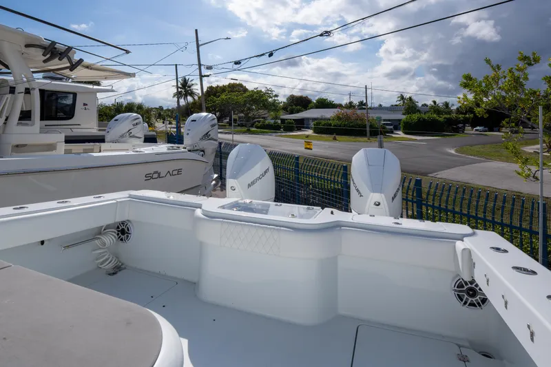 Slide: The Image of 2022 Freeman 34 boat with Mercury engines, docked near a Solace vessel. - 19