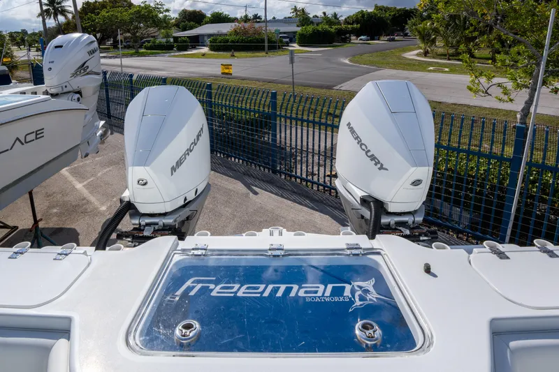 Slide: The Image of Freeman 34 boat with dual Mercury outboard engines, 2022 model, parked outdoors. - 21
