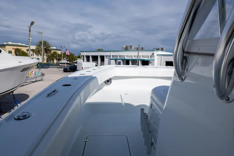 Slide: The Image of 2022 Freeman 34 boat deck with sleek design, docked at marina under cloudy sky. - 8
