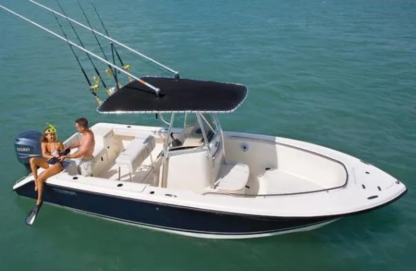 Slide: The Image of 2012 Pursuit C 230 Center Console boat on a sunny lake with other boats nearby. - 12