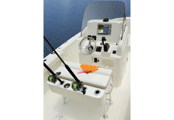 Slide: The Image of 2012 Pursuit C 230 Center Console boat on calm water, featuring navigation equipment. - 13