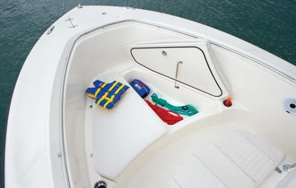 Slide: The Image of 2012 Pursuit C 230 Center Console boat on water with cityscape view. - 14