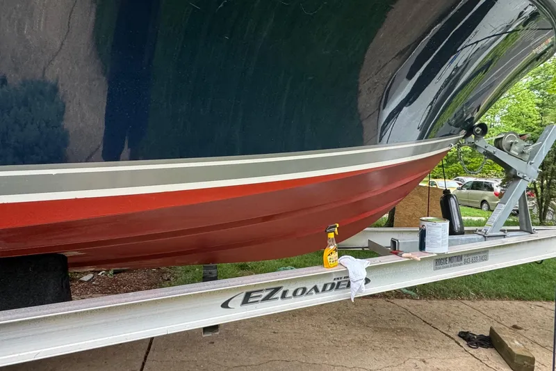 Slide: The Image of 2012 Pursuit C 230 Center Console boat on trailer, parked in driveway. - 2