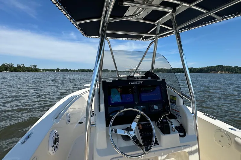 Slide: The Image of 2012 Pursuit C 230 Center Console boat on EZ Loader trailer, parked in driveway. - 3