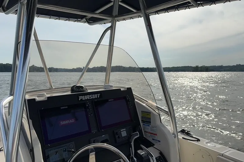 Slide: The Image of 2012 Pursuit C 230 Center Console boat on trailer, undergoing maintenance. - 4