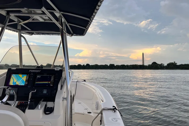 Slide: The Image of 2012 Pursuit C 230 Center Console boat on trailer, parked in driveway. - 5