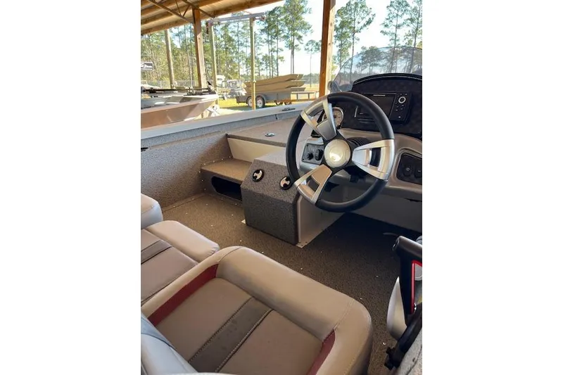 Slide: The Image of Interior of 2025 G3 Sportsman 1710 boat with steering wheel and seating. - 4