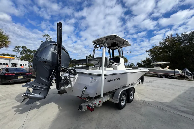 Slide: The Image of 2026 Sea Born FX261 Bay boat on trailer under a partly cloudy sky. - 12