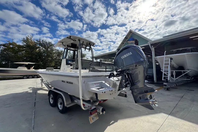 Slide: The Image of 2026 Sea Born FX261 Bay boat with Yamaha engine on trailer under cloudy sky. - 16