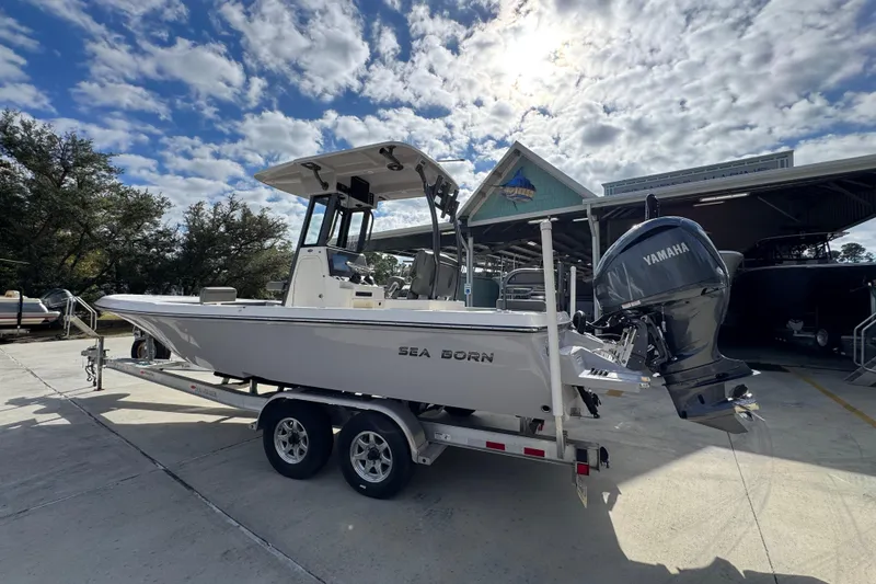 Slide: The Image of 2026 Sea Born FX261 Bay boat on trailer under cloudy sky. - 17