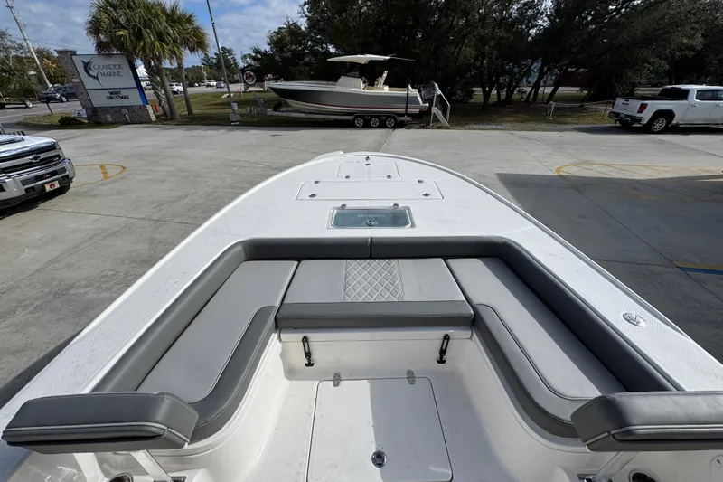 Slide: The Image of 2026 Sea Born FX261 Bay boat interior with cushioned seating and storage compartments. - 19