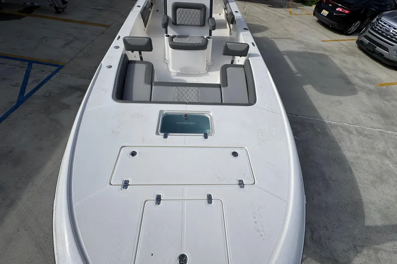 Slide: The Image of 2026 Sea Born FX261 Bay boat with spacious deck and seating, parked in a lot. - 21