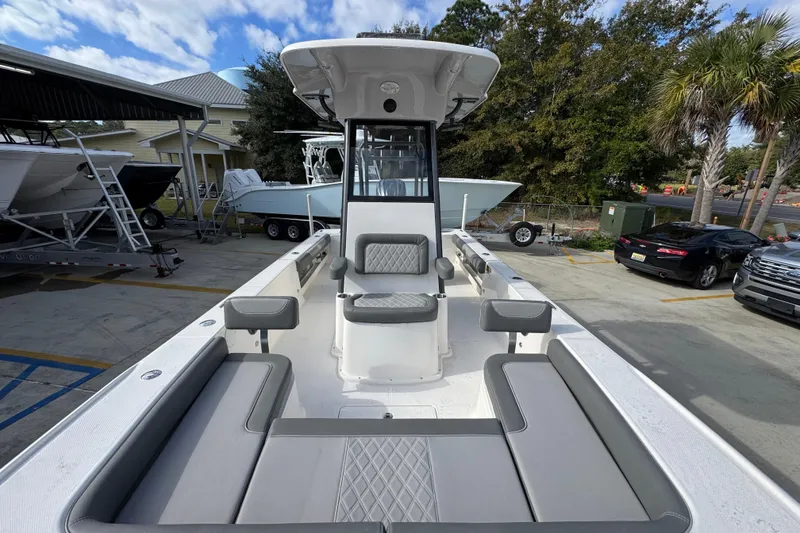 Slide: The Image of 2026 Sea Born FX261 Bay boat with spacious seating and modern design in a marina setting. - 23