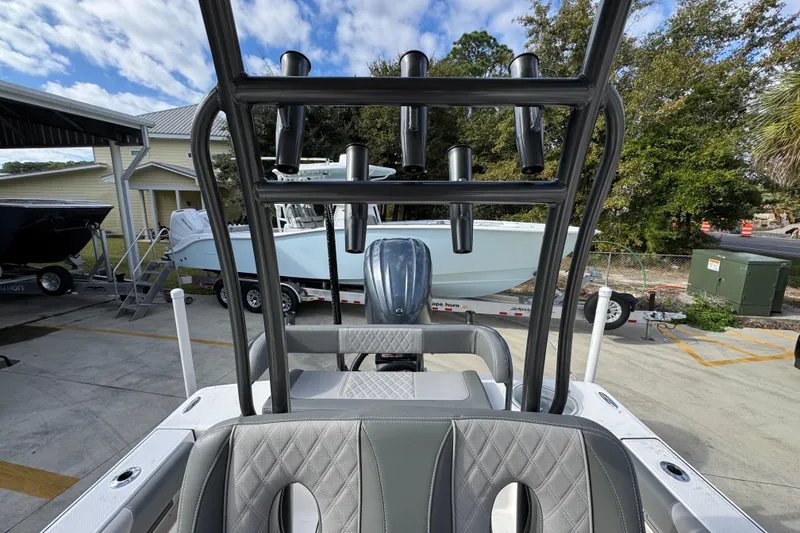 Slide: The Image of 2026 Sea Born FX261 Bay boat with rod holders, parked outdoors under a cloudy sky. - 29