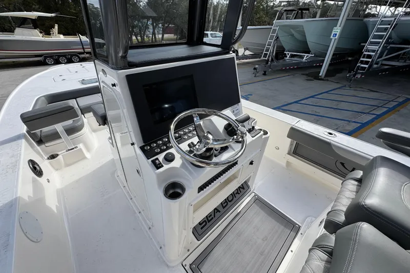 Slide: The Image of 2026 Sea Born FX261 Bay boat cockpit with steering wheel and control panel. - 31