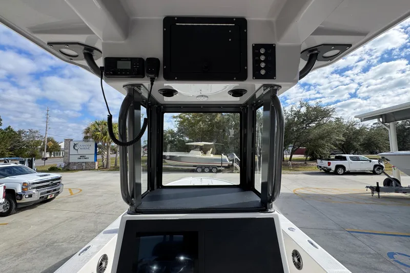 Slide: The Image of 2026 Sea Born FX261 Bay boat console with electronics, parked outdoors under a partly cloudy sky. - 33