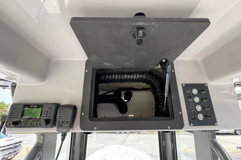Slide: The Image of 2026 Sea Born FX261 Bay boat console with open storage, Garmin radio, and control panel. - 34