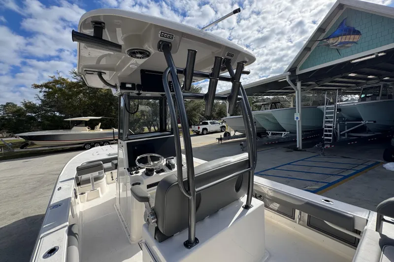 Slide: The Image of 2026 Sea Born FX261 Bay boat interior with console and seating, parked at a marina. - 38