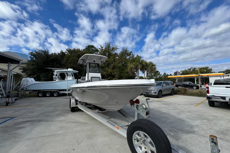 Slide: The Image of 2026 Sea Born FX261 Bay boat on trailer under a partly cloudy sky. - 7