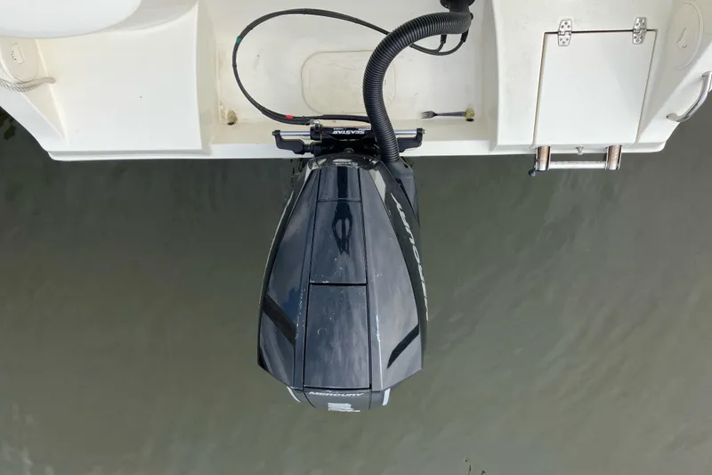 Slide: The Image of 2024 Cobia 220 Dual Console boat with a powerful outboard motor, viewed from above. - 7