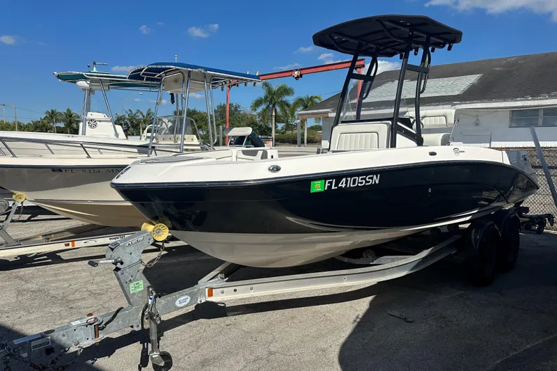 Slide: The Image of 2020 Yamaha Boats 210 FSH on trailer, parked outdoors under clear blue sky. - 10