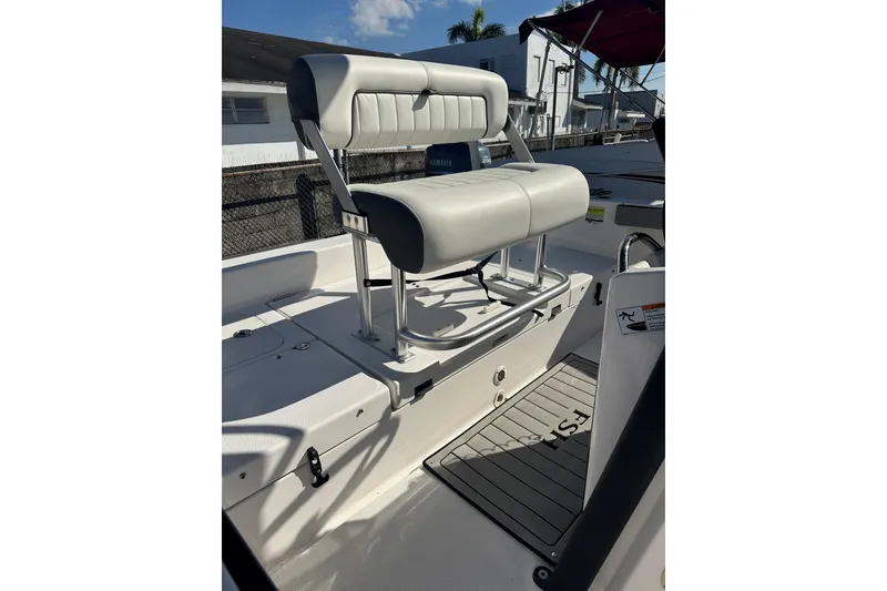Slide: The Image of 2020 Yamaha Boats 210 FSH interior with cushioned seating and sleek design. - 12